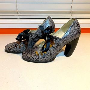 John Fluevog grey Mary Jane style 3” heels with ribbon bow.